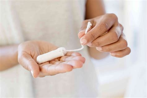<b>Girl</b> is choosing product for absorbing menstrual blood. . Video of girl inserting tampon